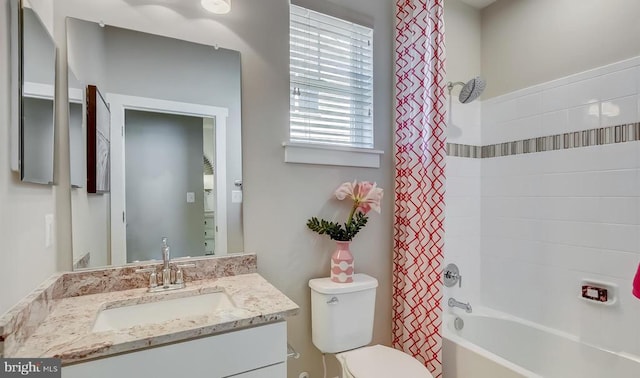 full bathroom with shower / tub combo, vanity, and toilet