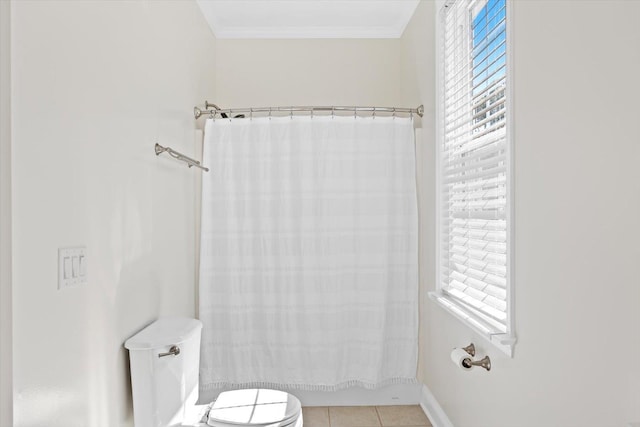 bathroom featuring ornamental molding, tile patterned floors, toilet, and shower / tub combo