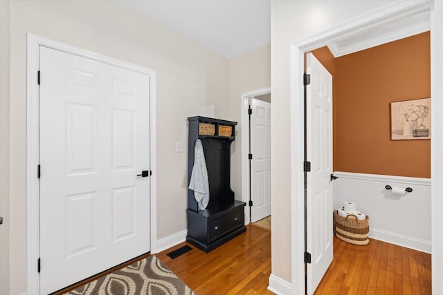 foyer entrance featuring crown molding and light hardwood / wood-style floors