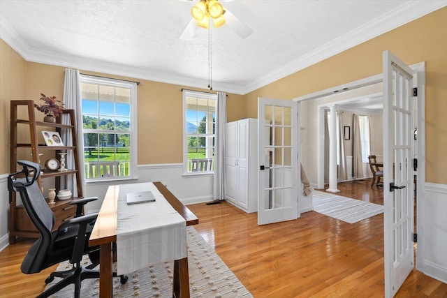 office with french doors, ornamental molding, light hardwood / wood-style flooring, and a textured ceiling