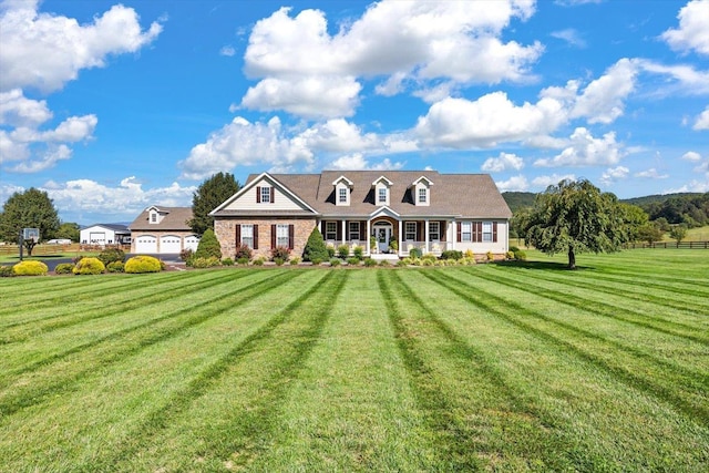 cape cod-style house featuring a garage and a front yard