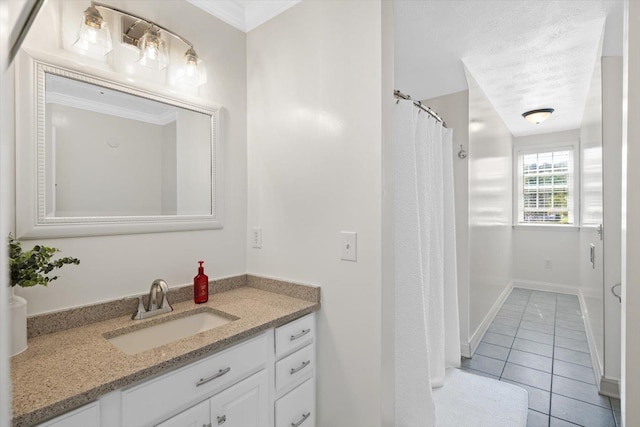 bathroom with tile patterned floors, vanity, and a textured ceiling