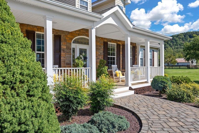 view of exterior entry with covered porch