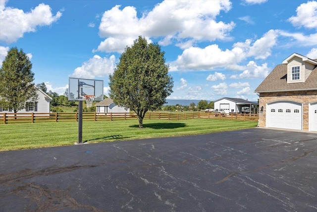 view of basketball court featuring a yard