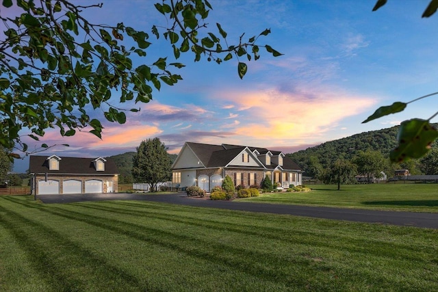 view of front of home with a yard and a garage