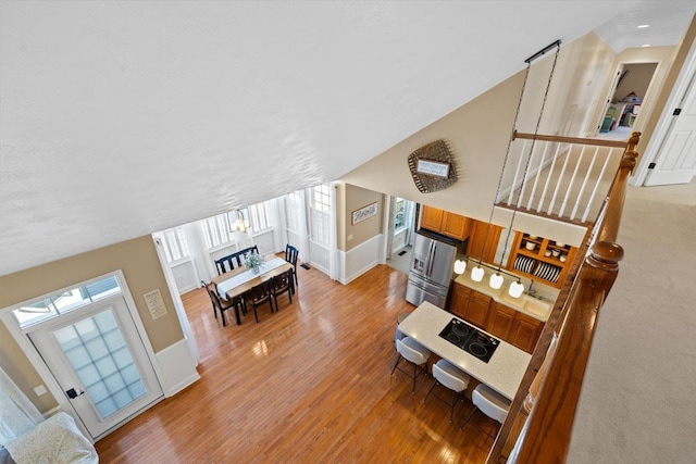 living room featuring lofted ceiling and light hardwood / wood-style flooring