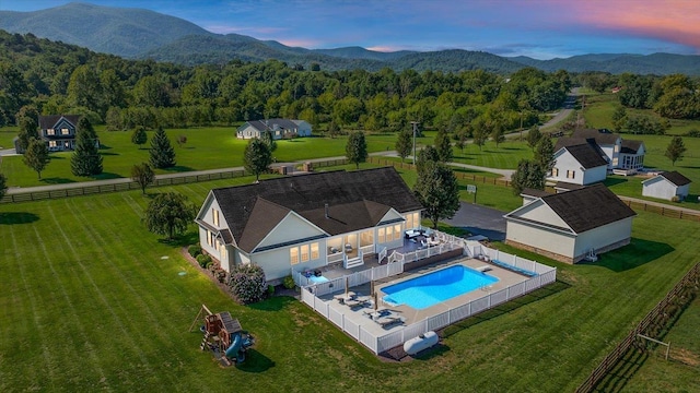 aerial view at dusk featuring a mountain view