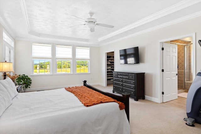 bedroom with crown molding, light colored carpet, and a raised ceiling