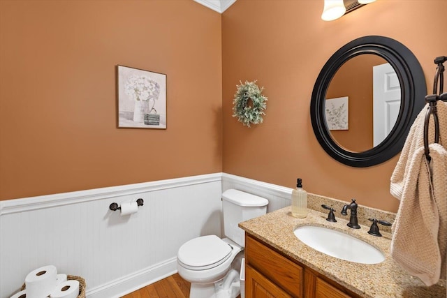 bathroom with vanity, hardwood / wood-style flooring, and toilet