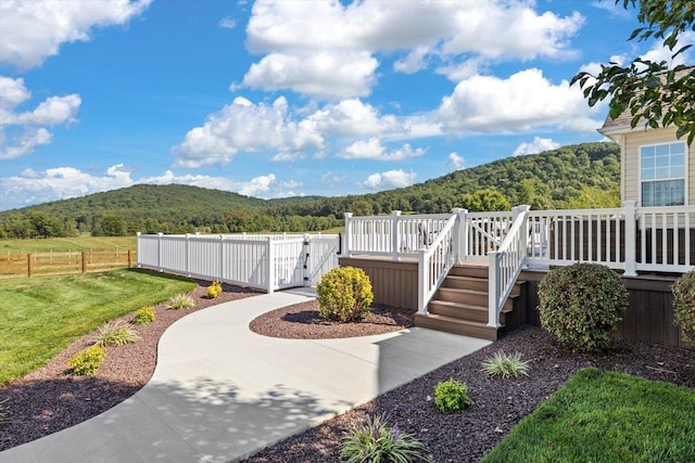 view of yard with a deck with mountain view