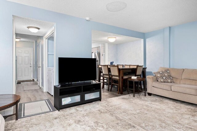 living room with hardwood / wood-style floors and a textured ceiling