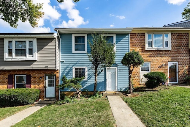 townhome / multi-family property featuring a front yard