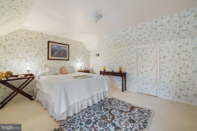 carpeted bedroom featuring vaulted ceiling