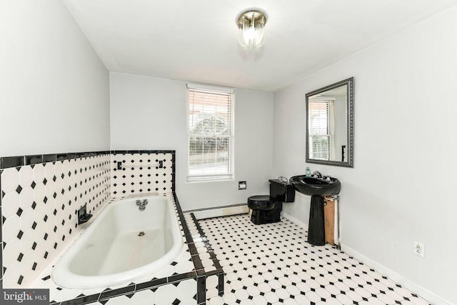 full bath featuring baseboards, a bath, toilet, and baseboard heating
