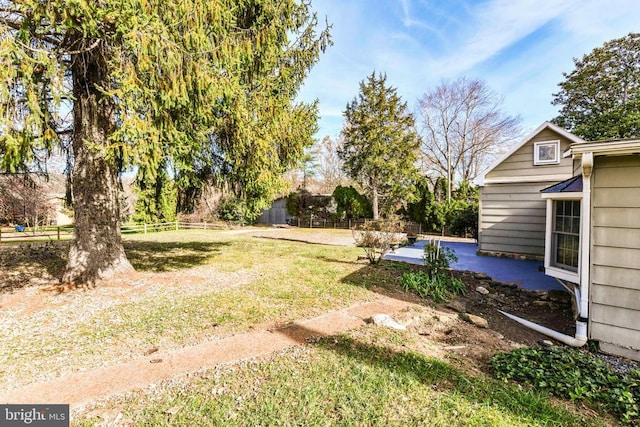 view of yard featuring fence and a patio