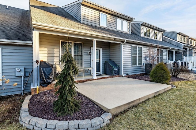 rear view of property with covered porch