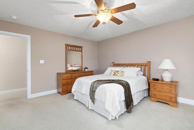 bedroom with light carpet and ceiling fan