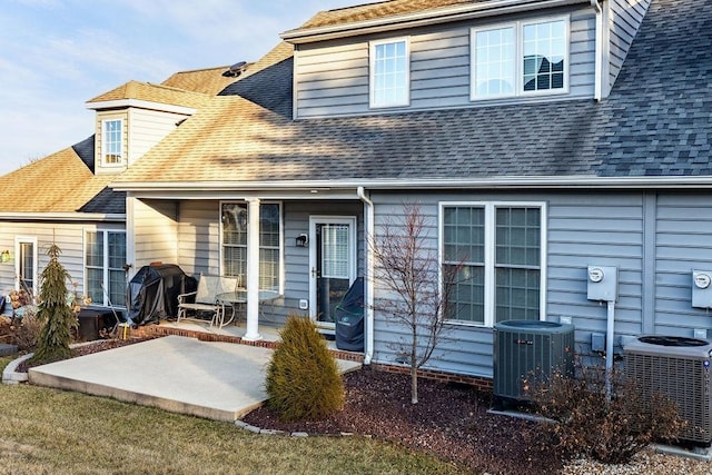 rear view of property featuring central AC and a patio area