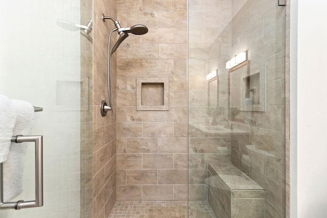 bathroom with a shower with door