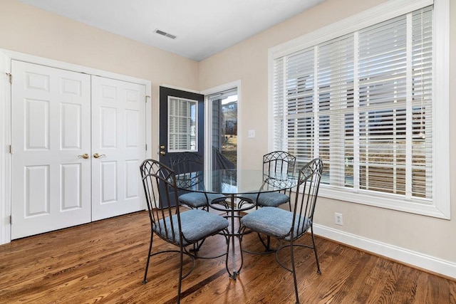 dining space featuring dark hardwood / wood-style floors