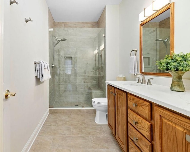 bathroom featuring walk in shower, vanity, and toilet