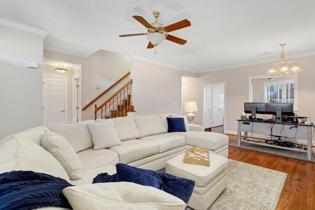 living room with crown molding, hardwood / wood-style floors, and ceiling fan