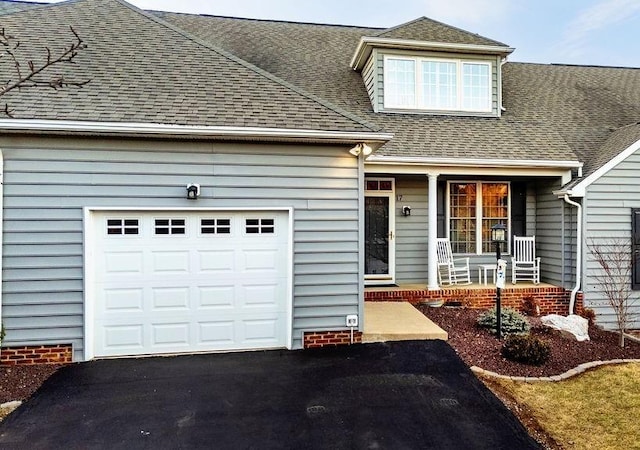 view of front facade featuring a garage and covered porch