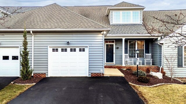 view of front of house featuring a porch and a garage