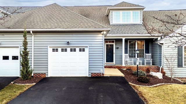 view of front facade with a garage and covered porch