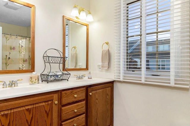 bathroom with vanity and a shower with shower curtain