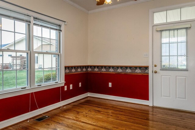 interior space with ornamental molding, wood-type flooring, and a wealth of natural light