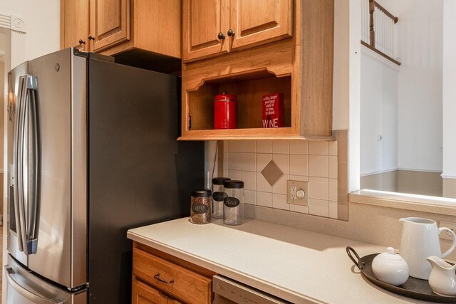 kitchen featuring stainless steel refrigerator with ice dispenser and decorative backsplash