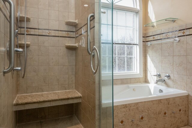 bathroom with independent shower and bath and tile walls