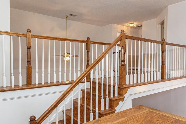 stairway with hardwood / wood-style floors