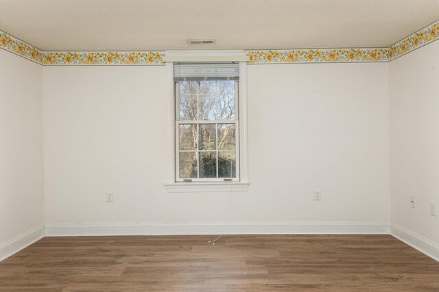 empty room featuring dark wood-type flooring