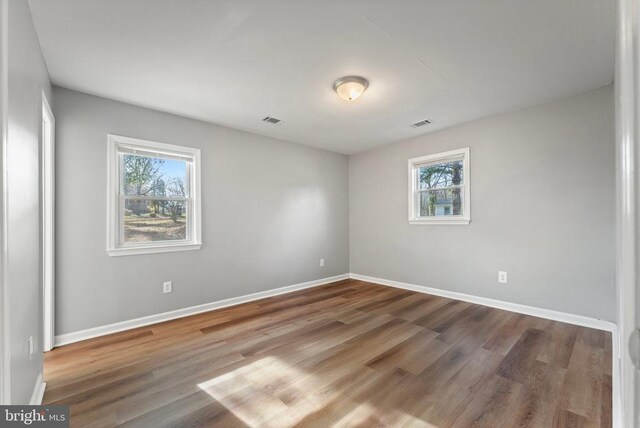 spare room with wood-type flooring