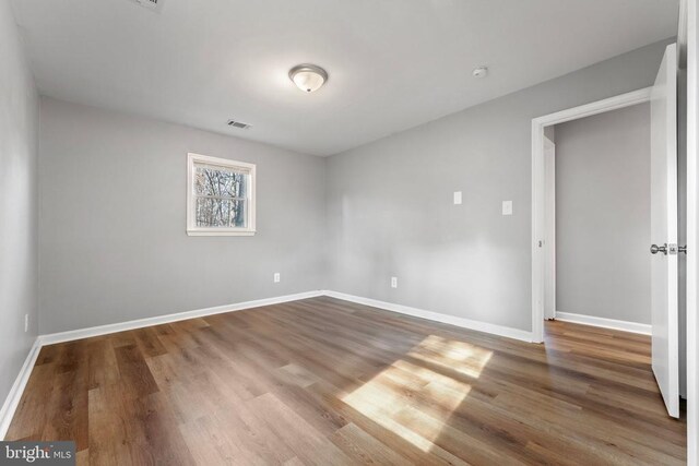 spare room featuring wood-type flooring