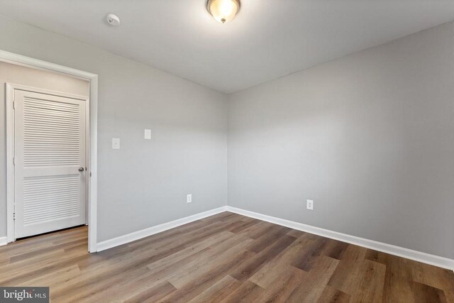 unfurnished room with hardwood / wood-style floors