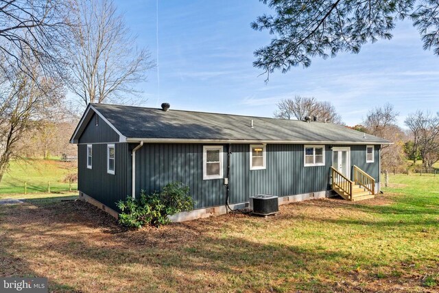 view of home's exterior with central AC unit and a lawn