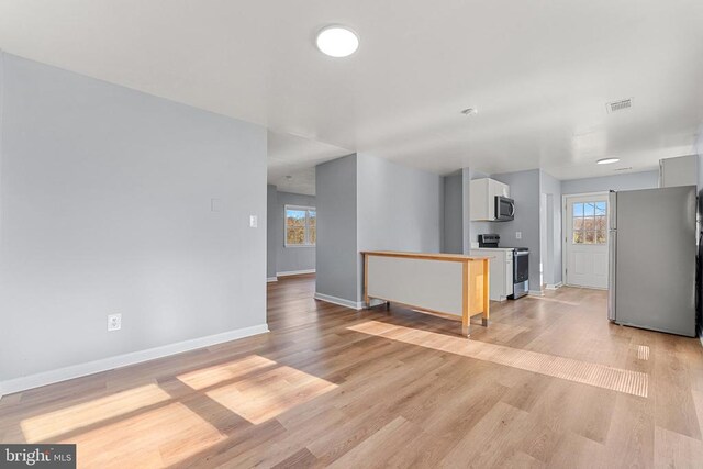 kitchen with sink, dishwasher, light hardwood / wood-style floors, and white cabinets