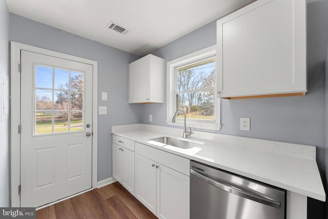 kitchen featuring sink, white cabinets, and dishwasher