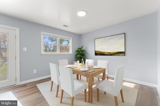 dining space featuring light wood-type flooring