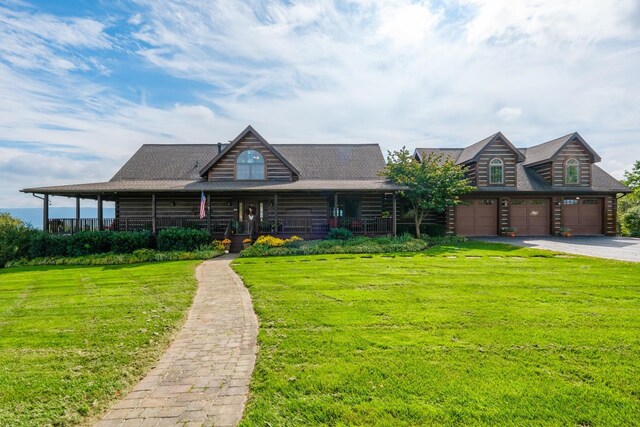 log-style house featuring a garage, covered porch, and a front lawn