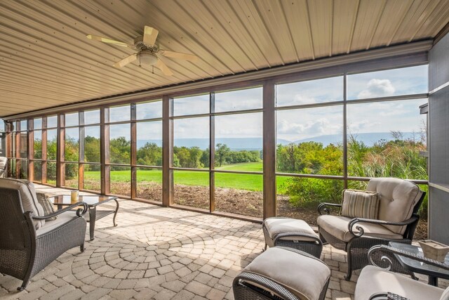 sunroom featuring ceiling fan