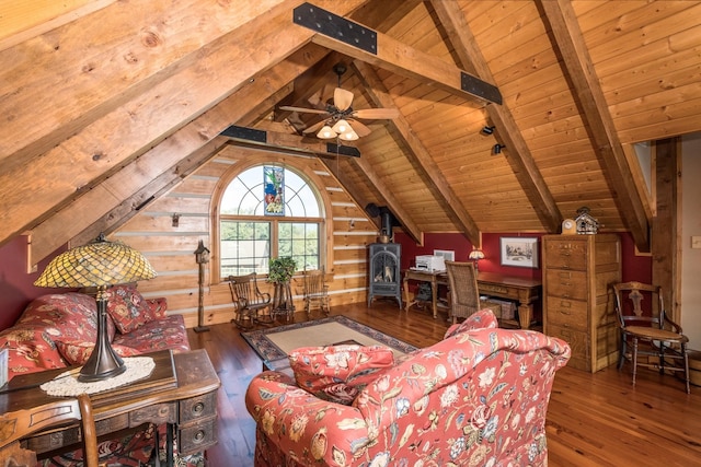 living room with lofted ceiling with beams, hardwood / wood-style flooring, a wood stove, and wooden ceiling