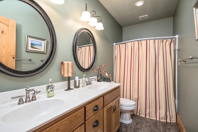 bathroom featuring vanity, curtained shower, and toilet