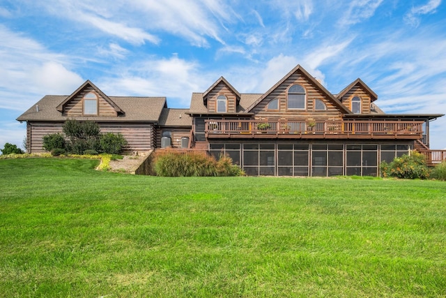 rear view of house with a wooden deck and a lawn