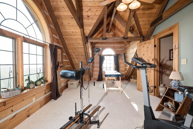 exercise room with lofted ceiling, ceiling fan, carpet flooring, wooden ceiling, and wood walls