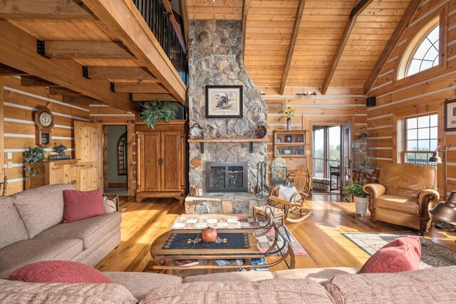 living room featuring wood ceiling, a fireplace, hardwood / wood-style flooring, and wood walls