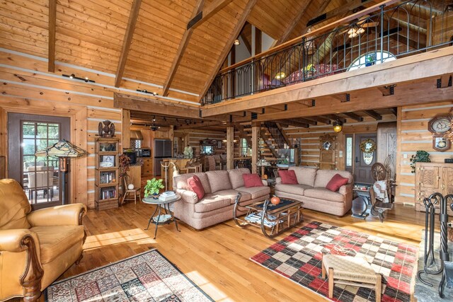 living room featuring wood ceiling, wood-type flooring, wooden walls, and vaulted ceiling with beams